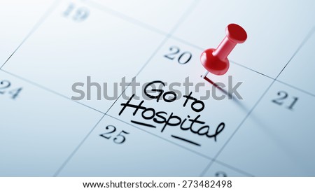 Concept image of a Calendar with a red push pin. Closeup shot of a thumbtack attached. The words Go to Hospital written on a white notebook to remind you an important appointment.