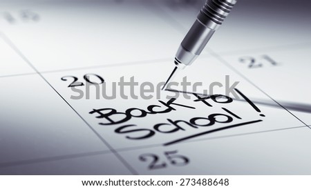 Concept image of a Calendar with a golden dart stick. The words Back to school written on a white notebook to remind you an important appointment.