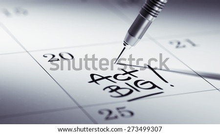 Concept image of a Calendar with a golden dart stick. The words Act BIG written on a white notebook to remind you an important appointment.