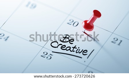 Concept image of a Calendar with a red push pin. Closeup shot of a thumbtack attached. The words Be Creative written on a white notebook to remind you an important appointment.