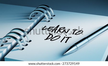 Closeup of a personal agenda setting an important date writing with pen. The words Learn to do it written on a white notebook to remind you an important appointment.