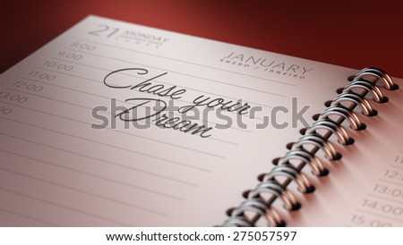 Closeup of a personal calendar setting an important date representing a time schedule. The words Chase your dream written on a white notebook to remind you an important appointment.