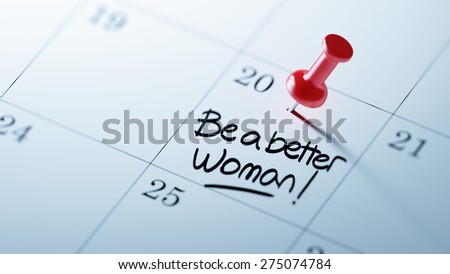 Concept image of a Calendar with a red push pin. Closeup shot of a thumbtack attached. The words Be a better woman written on a white notebook to remind you an important appointment.