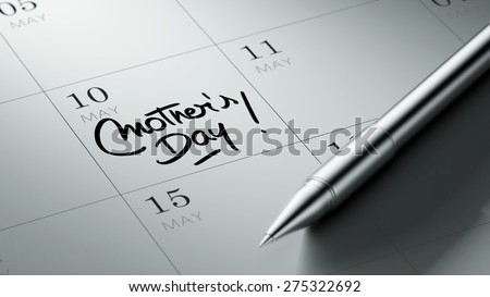 Closeup of a personal agenda setting an important date written with pen. The words Mother\'s Day written on a white notebook to remind you an important appointment.