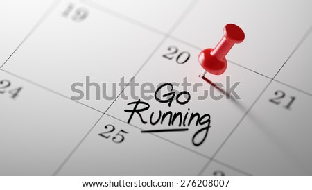 Concept image of a Calendar with a red push pin. Closeup shot of a thumbtack attached. The words Go running written on a white notebook to remind you an important appointment.