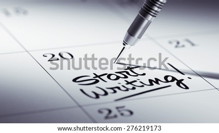 Concept image of a Calendar with a golden dart stick. The words Start Writing written on a white notebook to remind you an important appointment.