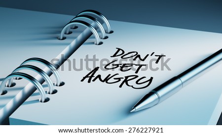 Closeup of a personal agenda setting an important date writing with pen. The words Don\'t get angry written on a white notebook to remind you an important appointment.