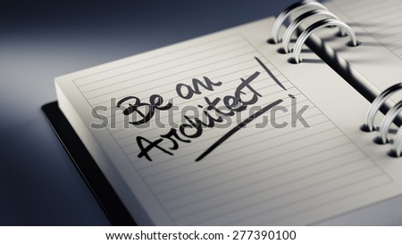 Closeup of a personal agenda setting an important date representing a time schedule. The words Be an Architect written on a white notebook to remind you an important appointment.