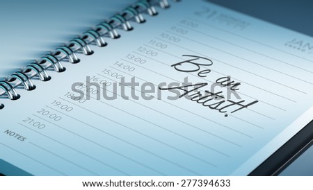 Closeup of a personal calendar setting an important date representing a time schedule. The words Be an Artist written on a white notebook to remind you an important appointment.