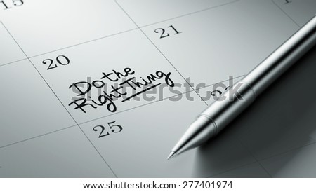 Closeup of a personal agenda setting an important date written with pen. The words Do the right thing written on a white notebook to remind you an important appointment.