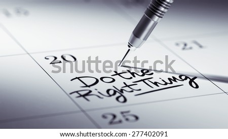 Concept image of a Calendar with a golden dart stick. The words Do the right thing written on a white notebook to remind you an important appointment.