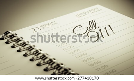 Closeup of a personal calendar setting an important date representing a time schedule. The words Call 911 written on a white notebook to remind you an important appointment.