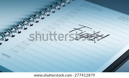 Closeup of a personal calendar setting an important date representing a time schedule. The words Fight written on a white notebook to remind you an important appointment.