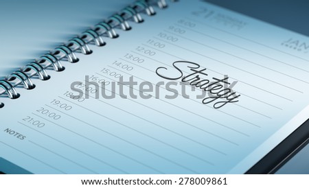 Closeup of a personal calendar setting an important date representing a time schedule. The words Strategy written on a white notebook to remind you an important appointment.