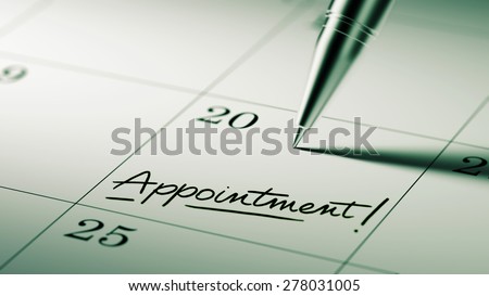 Closeup of a personal agenda setting an important date written with pen. The words Appointment written on a white notebook to remind you an important appointment.