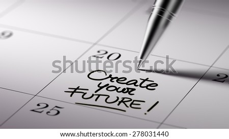 Closeup of a personal agenda setting an important date written with pen. The words Create your future written on a white notebook to remind you an important appointment.
