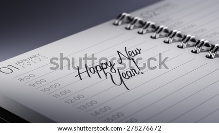 Closeup of a personal calendar setting an important date representing a time schedule. The words Happy New Year written on a white notebook to remind you an important appointment.