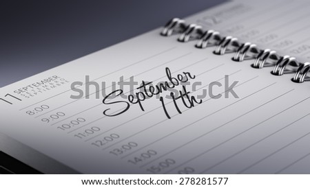 Closeup of a personal calendar setting an important date representing a time schedule. The words September 11th written on a white notebook to remind you an important appointment.