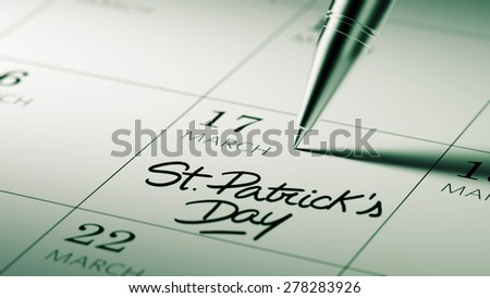 Closeup of a personal agenda setting an important date written with pen. The words St. Patrick's Day written on a white notebook to remind you an important appointment.