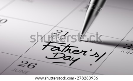 Closeup of a personal agenda setting an important date written with pen. The words Father\'s Day written on a white notebook to remind you an important appointment.