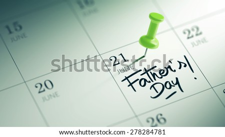Concept image of a Calendar with a green push pin. Closeup shot of a thumbtack attached. The words Father's Day written on a white notebook to remind you an important appointment.