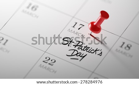 Concept image of a Calendar with a red push pin. Closeup shot of a thumbtack attached. The words St. Patrick\'s Day written on a white notebook to remind you an important appointment.