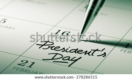 Closeup of a personal agenda setting an important date written with pen. The words President\'s Day written on a white notebook to remind you an important appointment.