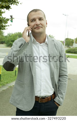 Entrepreneur calling Outdoor with a Mobile Phone