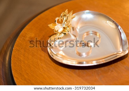wedding gold rings laying on the gold plate
