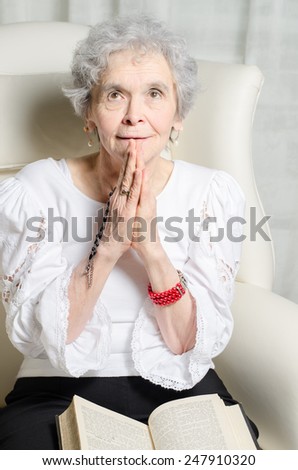 old woman with rosary and bible