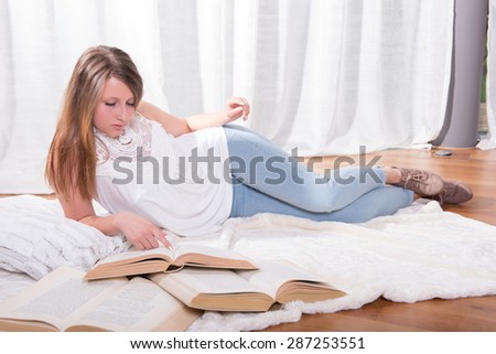 young student reading on blanket