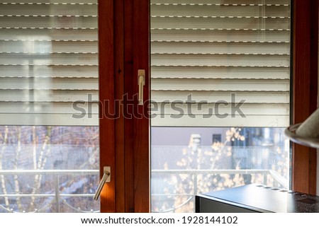 A half shut window with steel blinds, indoor cropped shot Foto stock © 