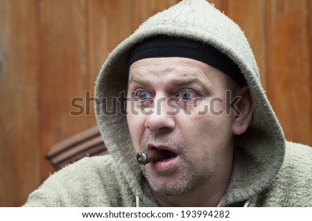 Emotional Portrait of a strange man with a cigar, looking surprised or frightened.