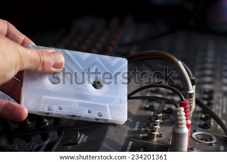 Hand ejecting a tape off cassette recorder
