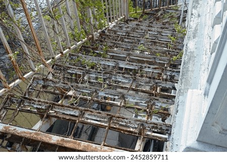 Similar – Foto Bild alte rostige Treppe mit Schäden gegen den blauen Himmel und die Wolken