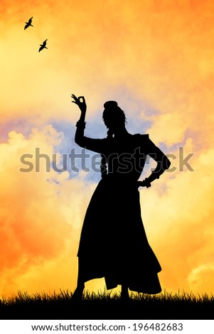Woman dancing indian dance at sunset