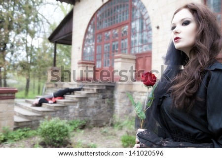 young widow in black dress and veil