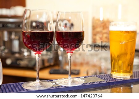 two glasses of wine and glass of beer