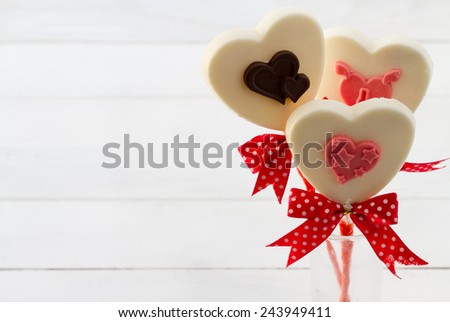 White chocolate heart shape on white wooden floor