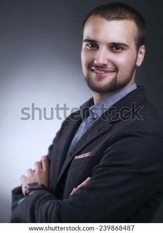 Business Style dressed Smiling Handsome Caucasian Man against Grey Background