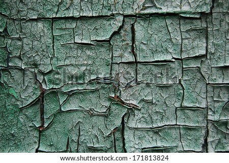 Old cracked paint pattern on rusty background. Peeling paint. Pattern of light-green grunge material. Damaged paint. Scratched old plate