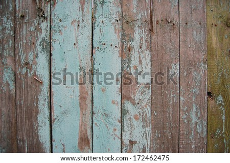 Wooden Palisade background. Close up of grey and green wooden fence panels. Vintage wood background. Old wooden fence. wood texture background. wood fence background
