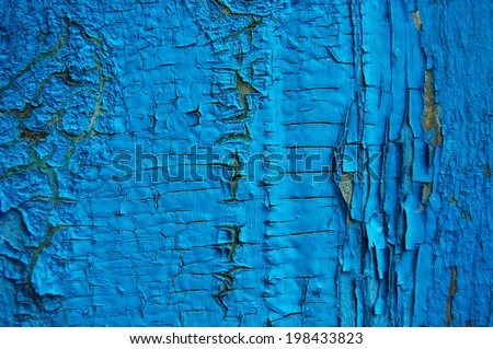 Cracked paint on a wooden wall. Wall from wooden planks with paint traces. old painted wood wall texture, grunge background, cracked paint.