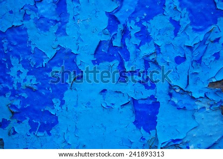 Old cracked paint pattern on rusty background. Peeling paint. Pattern of rustic blue grunge material. Damaged paint on the metal surface. Scratched old metal plate