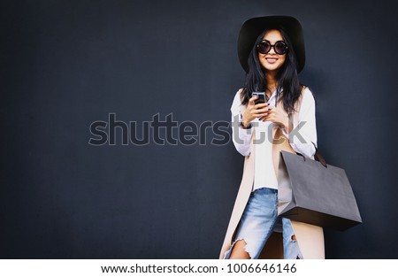 Similar – Image, Stock Photo Beautiful caucasian fashionly dressed girl standing outdoors with paper bag with purchases in the city.