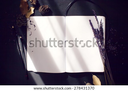 composition notebook, and dried plants