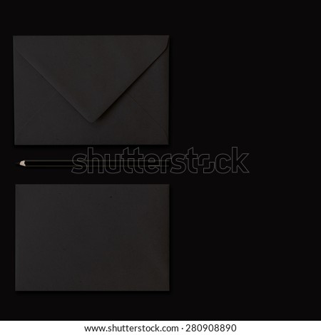 Black envelope on dark background, composition shifted to the left