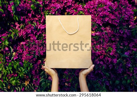a paper bag on a background of red flowers
