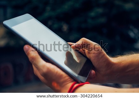 Man holding digital tablet, closeup. man working with a digital tablet