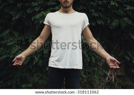 White t-shirt with copy space on a young man. Front view